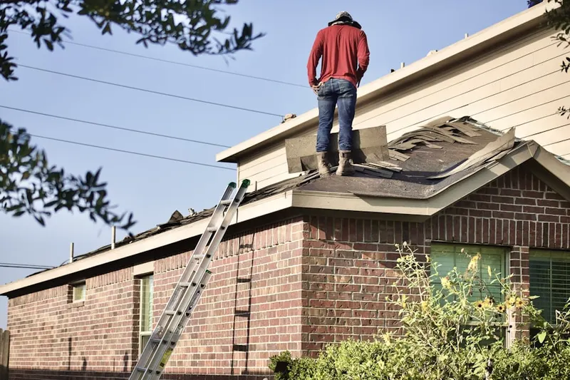 Professional roofer working on a residential roof in Century City